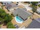 Aerial view of a home with a sparkling swimming pool and fenced backyard in a quiet residential neighborhood at 2816 Manor Hill Dr, Brandon, FL 33511