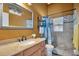 Bathroom featuring a granite counter, large mirror, shower, and toilet at 2816 Manor Hill Dr, Brandon, FL 33511