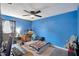 View of a cozy bedroom with blue walls, a ceiling fan, and a comfortable bed at 2816 Manor Hill Dr, Brandon, FL 33511