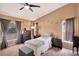 Comfortable bedroom featuring a ceiling fan, neutral carpet, and ample natural light from multiple windows at 2816 Manor Hill Dr, Brandon, FL 33511