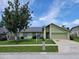 Charming single-story home featuring lush lawn, mature trees and a attached two-car garage at 2816 Manor Hill Dr, Brandon, FL 33511