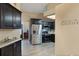 This modern kitchen has stainless appliances, sleek black cabinets, and beautiful gray wood-look tile flooring at 2816 Manor Hill Dr, Brandon, FL 33511