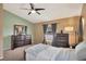 A comfortable main bedroom with neutral colors, two windows, and dark wood furniture at 2816 Manor Hill Dr, Brandon, FL 33511