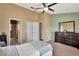 Comfortable main bedroom featuring an ensuite bathroom, walk-in closet, and a ceiling fan at 2816 Manor Hill Dr, Brandon, FL 33511