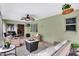 Comfortable patio with wicker furniture, ceiling fan, and subtle decor overlooking the backyard and the pool at 2816 Manor Hill Dr, Brandon, FL 33511