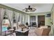 Charming patio featuring cozy seating areas, ceiling fans, decorative curtains, and a view of the pool at 2816 Manor Hill Dr, Brandon, FL 33511