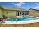 Backyard showcasing a sparkling pool, outdoor seating, and a well-maintained green space, creating a relaxing oasis at 2816 Manor Hill Dr, Brandon, FL 33511