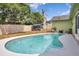 Backyard pool, privacy fence, and green space provide a serene and private outdoor setting at 2816 Manor Hill Dr, Brandon, FL 33511
