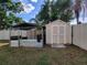 Backyard features a sturdy storage shed with dog kennel, perfect for tools and pet at 2816 Manor Hill Dr, Brandon, FL 33511