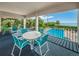 Balcony area with outdoor seating overlooking a pool and scenic water views at 300 S Florida Ave # 200J, Tarpon Springs, FL 34689