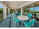 Spacious covered balcony with several seating arrangements and views of the community landscaping and waterway at 300 S Florida Ave # 200J, Tarpon Springs, FL 34689