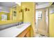 Sun-filled bathroom featuring a white vanity, tile shower, and beach-themed decor, creating a relaxing atmosphere at 300 S Florida Ave # 200J, Tarpon Springs, FL 34689