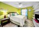 Comfortable bedroom featuring vibrant green walls, large window, and stylish furnishings, perfect for relaxation at 300 S Florida Ave # 200J, Tarpon Springs, FL 34689