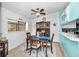Inviting dining room with wood table, four chairs, and natural light from the window at 300 S Florida Ave # 200J, Tarpon Springs, FL 34689