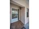 A clean and well-lit condo entryway with tile flooring, screen door and a charming exterior light at 300 S Florida Ave # 200J, Tarpon Springs, FL 34689