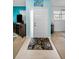 Entryway view featuring a patterned rug, bright blue accent wall, and tiled flooring at 300 S Florida Ave # 200J, Tarpon Springs, FL 34689