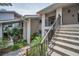 Condo exterior features clean lines, convenient stair access and lush tropical landscaping at 300 S Florida Ave # 200J, Tarpon Springs, FL 34689