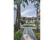 Charming condo complex exterior with mature trees and well-manicured landscaping at 300 S Florida Ave # 200J, Tarpon Springs, FL 34689