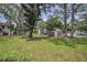 View of the property featuring lush green lawns, mature trees, and well-maintained building exteriors in a tranquil setting at 300 S Florida Ave # 200J, Tarpon Springs, FL 34689