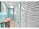 Hallway with tile floors and storage closets with bright white decor and beach themed artwork at 300 S Florida Ave # 200J, Tarpon Springs, FL 34689