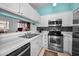 Bright and open kitchen with stainless steel appliances, mosaic tile backsplash, and views to an eat-in kitchen at 300 S Florida Ave # 200J, Tarpon Springs, FL 34689
