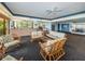 Inviting resident lounge featuring comfortable seating, fireplace, ceiling fan, and large windows for natural light at 300 S Florida Ave # 200J, Tarpon Springs, FL 34689
