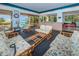 Bright community lounge area with rattan sofas, reception desk, and tables offering a relaxing atmosphere at 300 S Florida Ave # 200J, Tarpon Springs, FL 34689