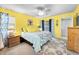 Bright main bedroom features a ceiling fan, large windows, ensuite bathroom, and ample closet space at 300 S Florida Ave # 200J, Tarpon Springs, FL 34689