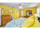 Sun-filled bedroom with en-suite bathroom, ceiling fan, and beach-themed decor, creating a relaxing atmosphere at 300 S Florida Ave # 200J, Tarpon Springs, FL 34689