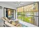 Relaxing patio space with comfortable seating, a ceiling fan, and a view of the outdoors through a large sliding glass door at 300 S Florida Ave # 200J, Tarpon Springs, FL 34689