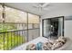 Charming patio featuring floral seating, tile floors, and retractable screens for comfortable outdoor living at 300 S Florida Ave # 200J, Tarpon Springs, FL 34689