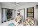 Inviting patio with floral seating, ceiling fan, and sliding glass doors offering serene views of lush surroundings at 300 S Florida Ave # 200J, Tarpon Springs, FL 34689