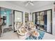 Bright patio with tile flooring, ceiling fan, and comfortable floral seating, seamlessly connecting indoor and outdoor living spaces at 300 S Florida Ave # 200J, Tarpon Springs, FL 34689