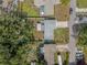 Aerial view of home with a backyard, mature trees, driveway, and street parking at 308 Jeanal Pl, Tampa, FL 33612