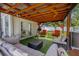 Relaxing back patio featuring an overhang with hanging lights, outdoor furniture, and a grill at 308 Jeanal Pl, Tampa, FL 33612
