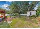 Wide backyard featuring a pond, covered patio, storage shed, well kept lawn, and a fire pit at 308 Jeanal Pl, Tampa, FL 33612