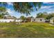 Expansive backyard with a covered patio, decorative pond, plenty of green space, and privacy fencing at 308 Jeanal Pl, Tampa, FL 33612