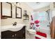 Well-lit bathroom featuring decorative shower curtain, dual mirrors, and modern fixtures at 308 Jeanal Pl, Tampa, FL 33612