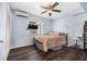Well-lit bedroom featuring wood-look tile flooring, ceiling fan, and comfortable furniture at 308 Jeanal Pl, Tampa, FL 33612