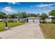 Picture of the exterior showcasing a single-story home with a manicured lawn and a spacious two-car garage at 308 Jeanal Pl, Tampa, FL 33612