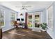 Bright home office with two windows, wood floors, modern monitors, and a door to the backyard at 308 Jeanal Pl, Tampa, FL 33612