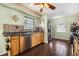 Bright kitchen with updated appliances, tile backsplash, wood cabinets, and dark wood-look tile flooring at 308 Jeanal Pl, Tampa, FL 33612