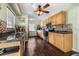 Charming kitchen with wood cabinets, dark countertops, tile backsplash and wood-look tile flooring at 308 Jeanal Pl, Tampa, FL 33612