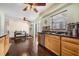 Cozy kitchen space with wood cabinets, dark countertops, stainless steel dishwasher and wood-look tile flooring at 308 Jeanal Pl, Tampa, FL 33612