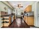 Functional kitchen featuring wood cabinets, stainless steel appliances, and warm wood-look tile flooring at 308 Jeanal Pl, Tampa, FL 33612