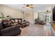 Living room featuring leather sofas, tile flooring, and access to a table-and-chairs dining area near a rear exit at 308 Jeanal Pl, Tampa, FL 33612