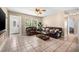 Cozy living room featuring tile flooring, a ceiling fan, a view of a window and an entryway, and comfortable leather sofas at 308 Jeanal Pl, Tampa, FL 33612