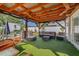 Outdoor living space featuring an overhang with decorative lights, outdoor seating, and landscaping at 308 Jeanal Pl, Tampa, FL 33612