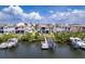 Aerial view of waterfront homes showcasing backyard docks and boat lifts, perfect for boating enthusiasts at 3122 Christophers Watch Ln, Ruskin, FL 33570