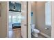 Cozy bathroom featuring a modern toilet, and views into the bedroom at 3122 Christophers Watch Ln, Ruskin, FL 33570